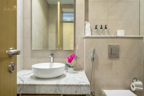 a bathroom with a sink and a mirror at Classic Canal View 2 Bhk 6pax in Dubai