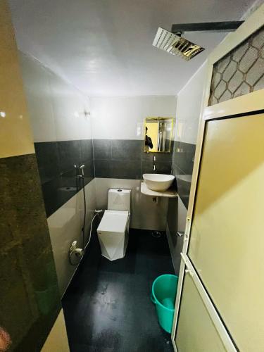 a small bathroom with a sink and a toilet at Ram Bhawan HomeStay in Vrindāvan