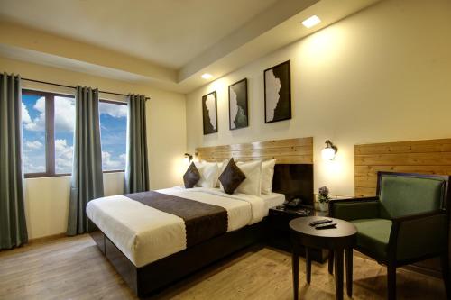a hotel room with a bed and a chair at Saltstayz Select - Nehru Place & New Friends Colony in New Delhi