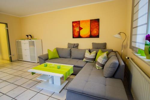 a living room with a couch and a table at Wohnung In Reckenfeld Mit Eigener Terrasse in Greven