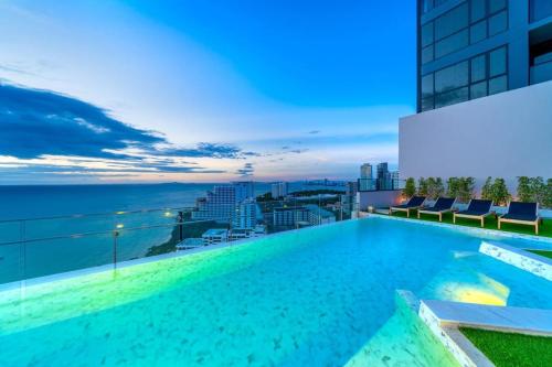 a swimming pool on the roof of a building at Breath Taking View, Amazing Sea View Room in Pattaya South