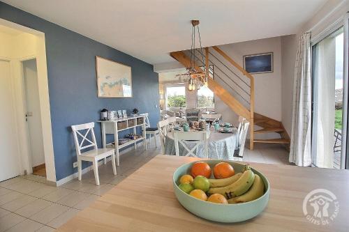 a bowl of fruit on a table in a kitchen at Glas ha gwenn in Plougrescant