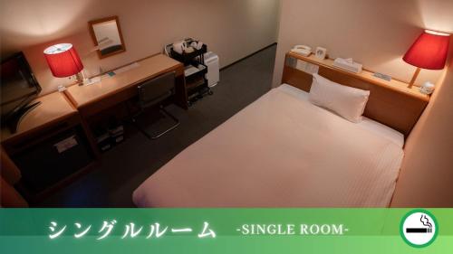 a hotel room with a large bed and a desk at ホテルグリーンヒル御坊駅前 in Gobō