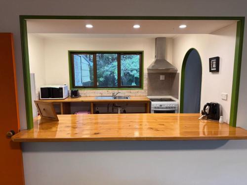 a kitchen with a large wooden counter top at The Whistling Frog Resort in Chaslands