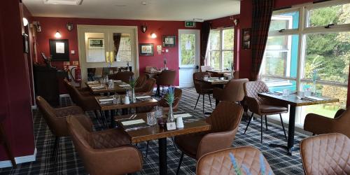 a restaurant with tables and chairs in a room at Bridge of Cally Hotel in Blairgowrie