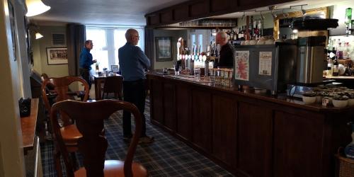 a group of men standing at a bar at Bridge of Cally Hotel in Blairgowrie