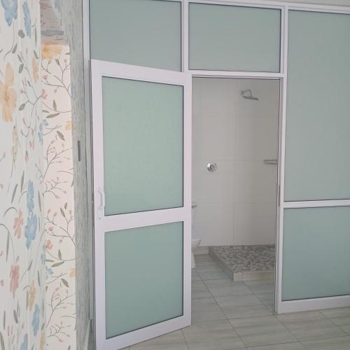 a bathroom with sliding glass doors in a room at Reeds House - a place to feel at home in Queenstown