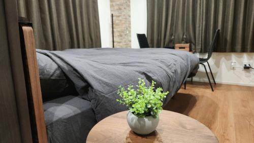 a bedroom with a bed and a table with a vase of flowers at 金澤屋Hirooka in Kanazawa