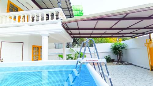a pool with a ladder next to a house at Retreat House 81 - BTS Onnut in Bangkok