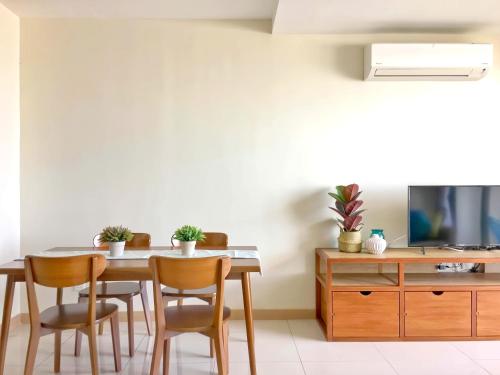 a dining room with a table and chairs at TimurBay Seafront Residence Kuantan in Kuantan