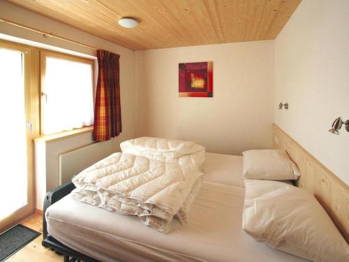 a bedroom with a bed in a room with a window at Chalet in Königsleiten near Hohe Tauern in Königsleiten