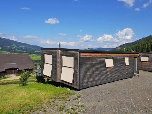 a small cabin with windows on top of a field at Loft in Gaal near Ski Slopes in Pirkach