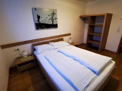 a bed in a bedroom with a picture on the wall at Loft in Gaal near Ski Slopes in Pirkach