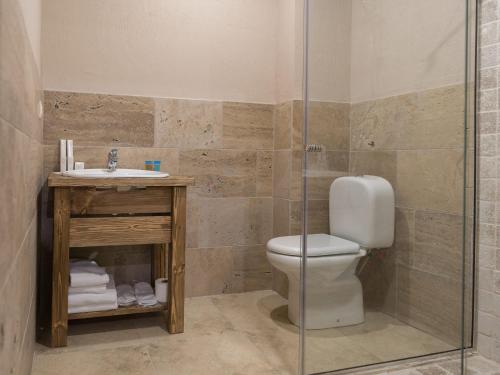 a bathroom with a toilet and a sink and a shower at Apricot Aghveran Resort in Agveran