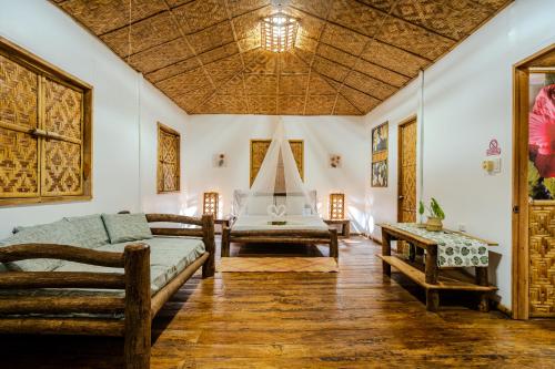 a room with a bed and a couch and a table at OM Horizon Ecoresort in Tocdoc