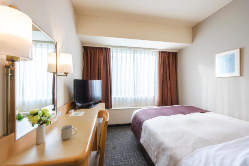 a hotel room with a bed and a television at Tokyo Bay Ariake Washington Hotel in Tokyo