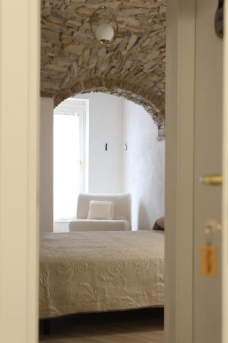a bedroom with a bed and a chair in a room at Il Viandante Bed & Breakfast in Roseto Valfortore