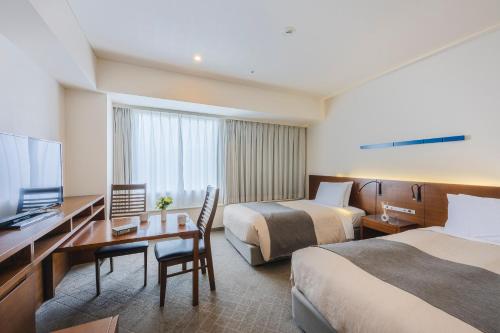 a hotel room with two beds and a flat screen tv at Tokyo Bay Ariake Washington Hotel in Tokyo