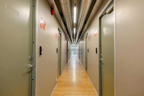 a corridor of corridors in a hospital with doors open at Just Rest Automatic Hostel in Viljandi
