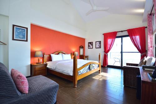 a bedroom with a bed and a red wall at Ji Li Ya Lan Homestay in Chenggong