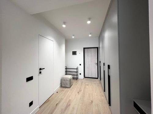 a room with a hallway with white walls and wooden floors at Panoramic Lake View in Chişinău