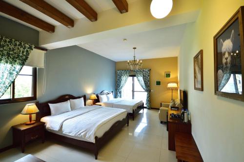 a bedroom with two beds and a tv in it at Ji Li Ya Lan Homestay in Chenggong