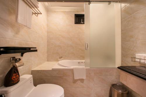 a bathroom with a toilet and a sink at Champton Hanoi Hotel in Hanoi