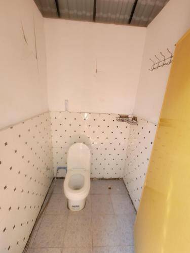 a small bathroom with a toilet in a stall at Top View Kohrong in Koh Rong