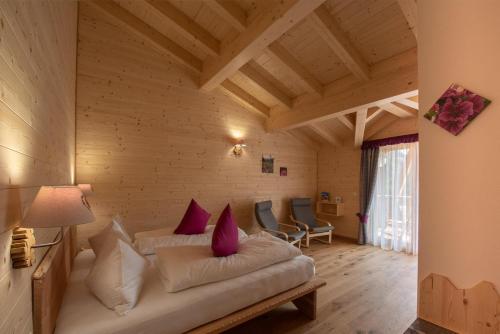 a living room with a couch in a room at Eco-Green Fiores Agriturismo in Vigo di Fassa