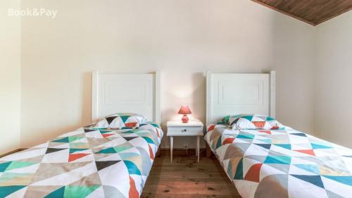 une chambre avec deux lits et une table avec une lampe dans l'établissement Gîte - Relais de Soubeille - Nature - Comminges Pyrenees, à Boulogne-sur-Gesse