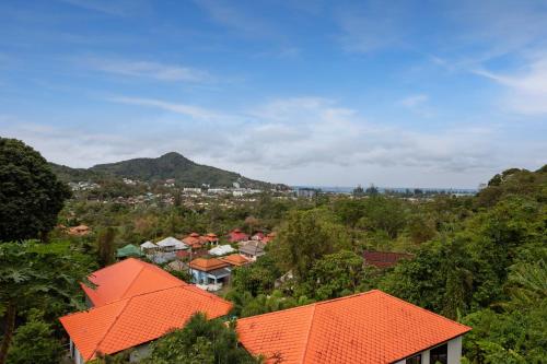 an aerial view of a town with orange roofs at Baan Chom View Kamala - SHA Plus in Kamala Beach