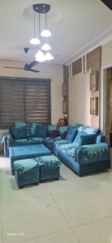 a living room with a blue couch in a room at City heart in Kharar