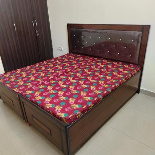 a bed in a room with avertisementatronatronstrationstrationstrationstration at City heart in Kharar