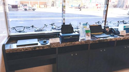 a counter with two laptops on top of it at Toyoko Inn Chiba Makuhari in Chiba