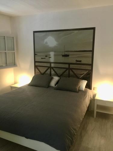 a bedroom with a bed with a large picture on the wall at CABALLITO DE MAR (SEAHORSE) in Playa Blanca