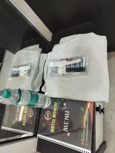 a bottle of water and a book in a drawer at Hotel Mohini in Kusrupāra