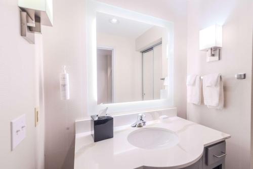 a white bathroom with a sink and a mirror at Homewood Suites - Doylestown in Warrington