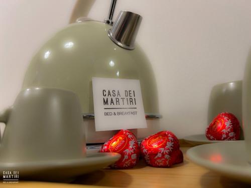 a jar with a sign on it next to some strawberries at Casa dei Martiri in Altamura