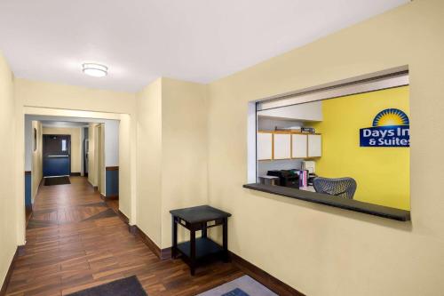 a hallway with a days inn and awhile sign on a wall at Birch Hill Suites Rochester - Med City in Rochester