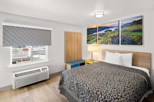 a hotel room with a bed and a window at Birch Hill Suites Rochester - Med City in Rochester