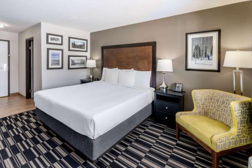 a hotel room with a bed and a chair at La Quinta Inn by Wyndham Steamboat Springs in Steamboat Springs