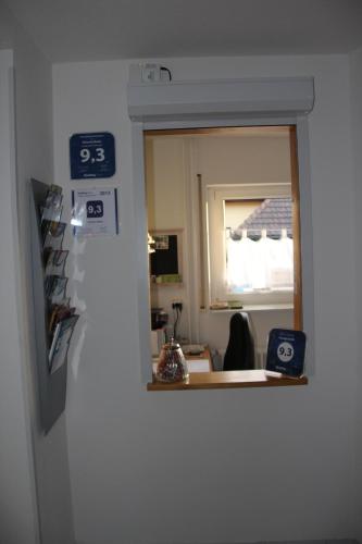 a mirror on the wall of a room at Pension Boitz in Rust
