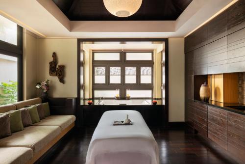 a living room with a couch and a window at Raffles Hainan Clear Water Bay in Sanya