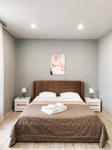 a bedroom with a large bed with two night stands at Apartments Domovik Стильна квартира, Миру 11 c кв 2 in Mukacheve