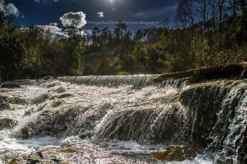 a waterfall on the side of a river at Casona Naviega in Navia