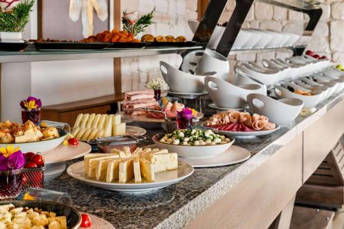 a buffet with many different types of food on a table at Ramada by Wyndham Fethiye Oludeniz in Oludeniz