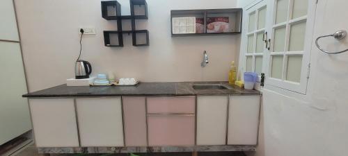 a kitchen counter with a sink and a door at shikary's palace near charminar in Hyderabad