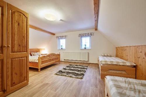 a large room with two beds and a door at Holiday Home Osada in Černý Dŭl