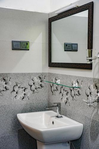 a bathroom with a sink and a mirror at Palm & Wild Hiriketiya in Dickwella