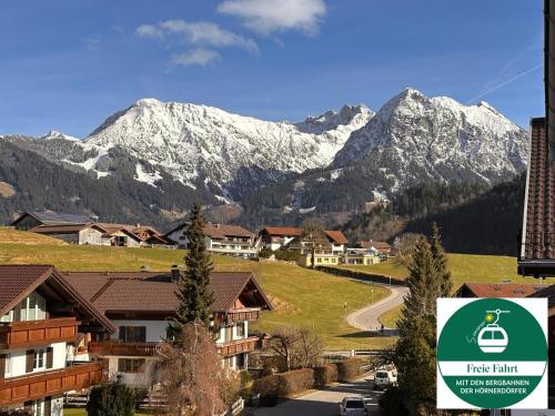 a village with a mountain range in the background at Ferienwohnung Bergrose in Obermaiselstein